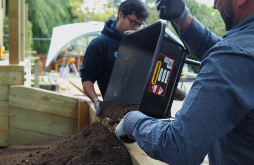 Local community activist, Sajid Hanif, and a member of Marco Longhi MP's team constructing a new planting area