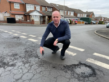 Marco Longhi MP examining the road condition on the Foxyards Estate in Dudley